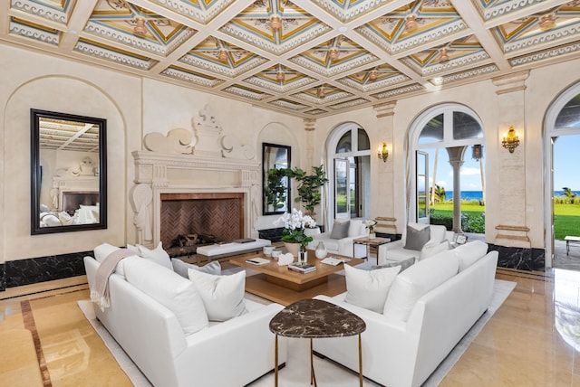 living room featuring ornate columns, crown molding, and a high end fireplace