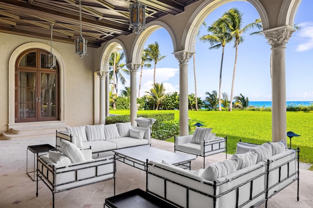 view of patio featuring outdoor lounge area, a water view, and french doors