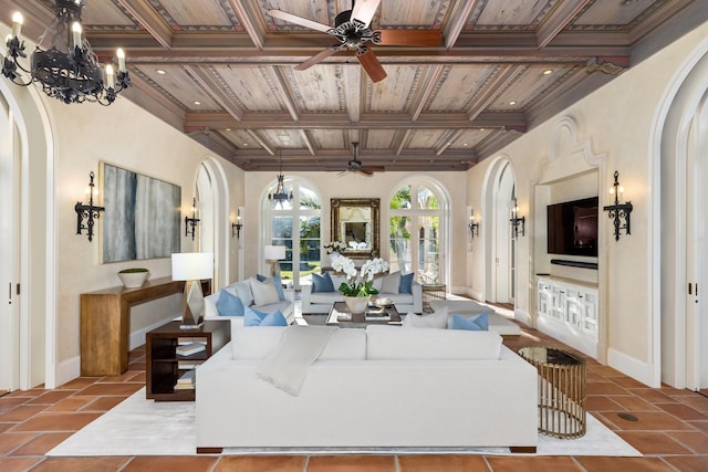 tiled living room featuring crown molding, french doors, ceiling fan with notable chandelier, and coffered ceiling