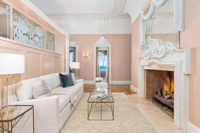 living room featuring ornamental molding and a fireplace