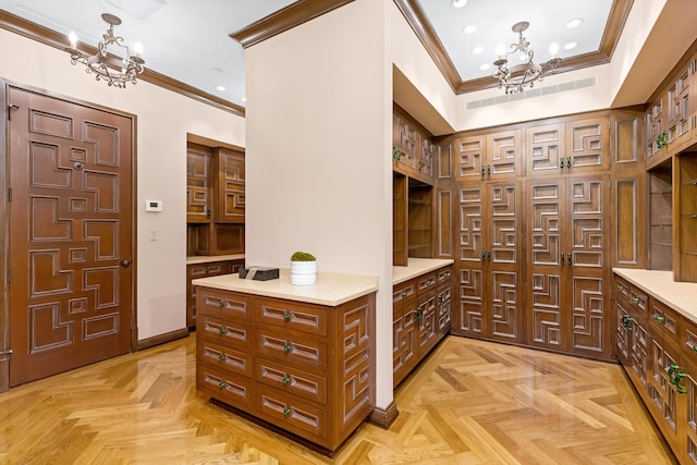 interior space featuring a chandelier, light parquet floors, and crown molding