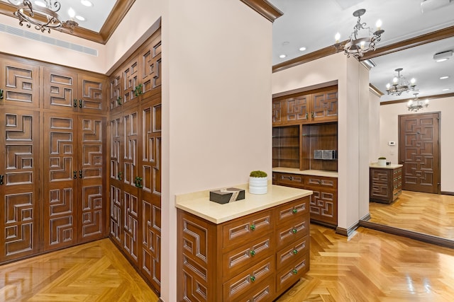 interior space featuring a chandelier, ornamental molding, and light parquet flooring