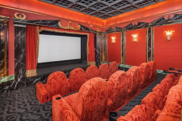 home theater room with dark carpet and coffered ceiling