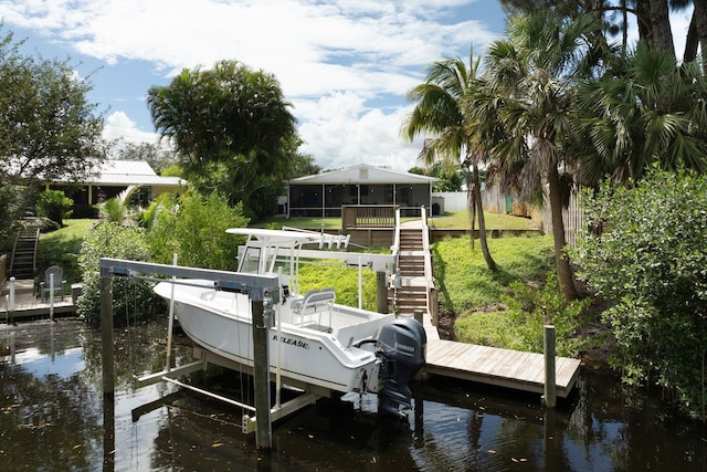 dock area with a water view and a yard