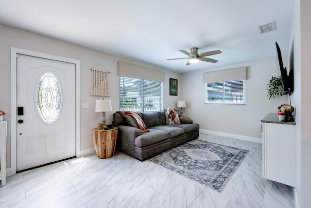 living room with a healthy amount of sunlight and ceiling fan