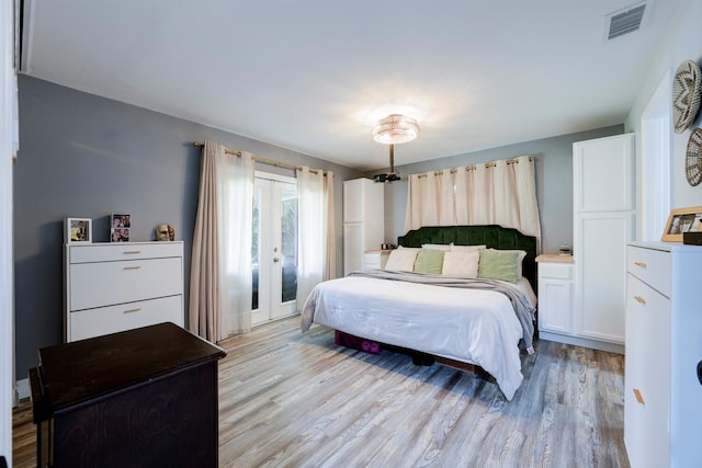 bedroom featuring french doors and light hardwood / wood-style floors