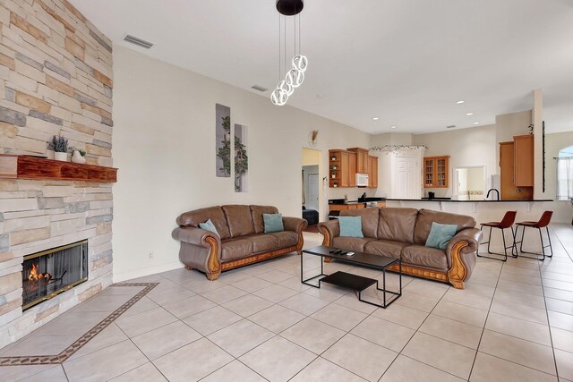 tiled living room featuring a fireplace