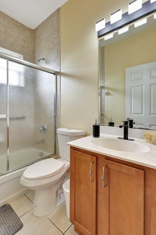 full bathroom with enclosed tub / shower combo, tile patterned floors, vanity, and toilet