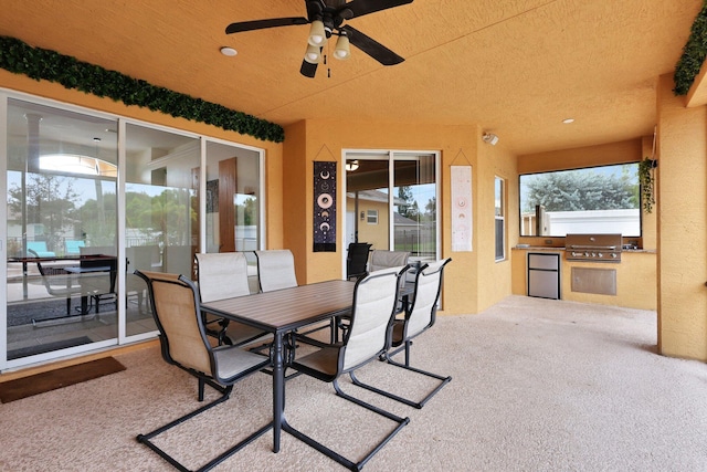 view of patio featuring ceiling fan, grilling area, and an outdoor kitchen