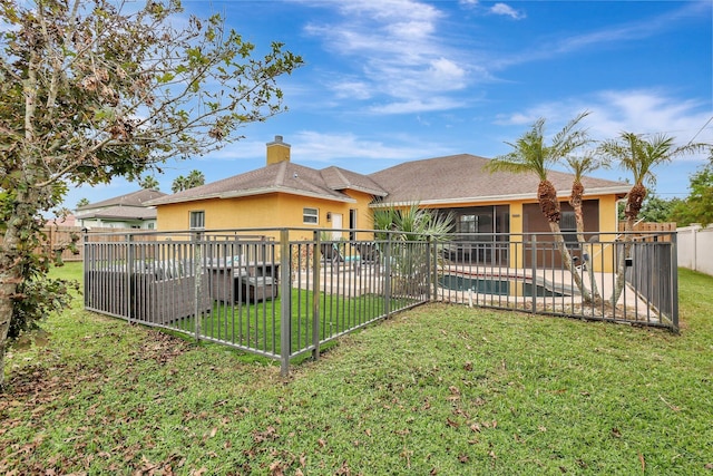 exterior space with a fenced in pool and a yard