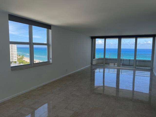 unfurnished room featuring a water view