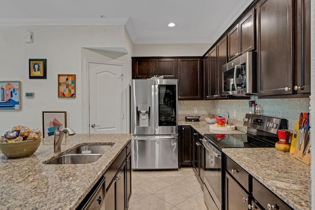 kitchen featuring light tile patterned floors, light stone counters, stainless steel appliances, sink, and dark brown cabinets