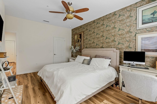 bedroom featuring hardwood / wood-style flooring and ceiling fan