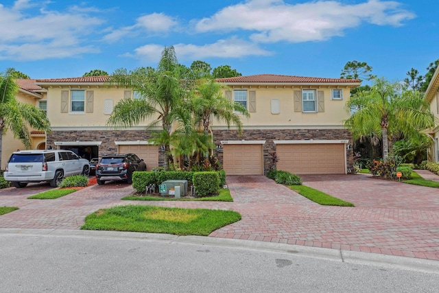 mediterranean / spanish home with a garage