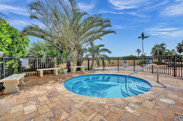 view of swimming pool with fence and a patio area
