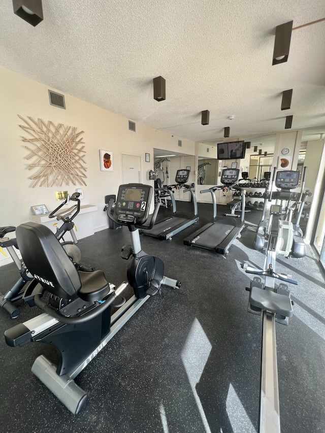 workout area with a textured ceiling and visible vents