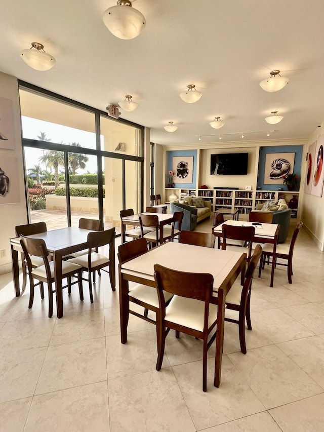dining space featuring a wall of windows and light tile patterned floors