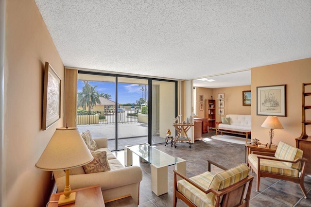 tiled living area featuring a textured ceiling and floor to ceiling windows