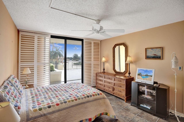 bedroom featuring a ceiling fan, tile patterned floors, a textured ceiling, and access to exterior