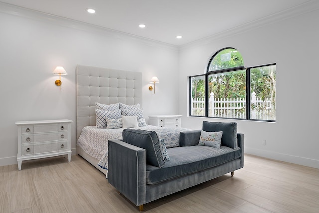 bedroom featuring multiple windows, light hardwood / wood-style flooring, and ornamental molding