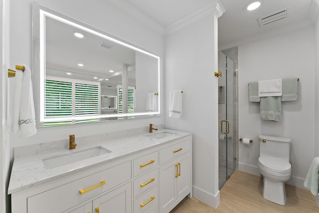 bathroom with walk in shower, ornamental molding, vanity, wood-type flooring, and toilet