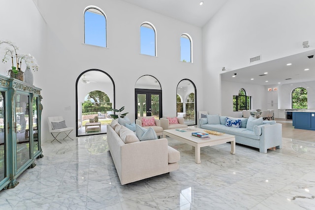 living room featuring a wealth of natural light and french doors