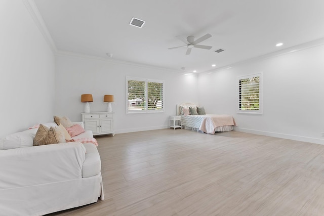 bedroom featuring light wood-type flooring, multiple windows, baseboards, and crown molding