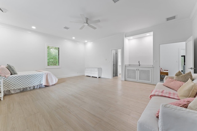 bedroom with light hardwood / wood-style flooring, ceiling fan, ornamental molding, and sink