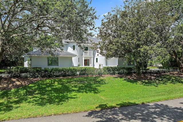 view of front of house featuring a front lawn and stucco siding