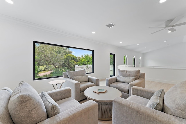 living room with baseboards, visible vents, lofted ceiling, light wood-style floors, and recessed lighting