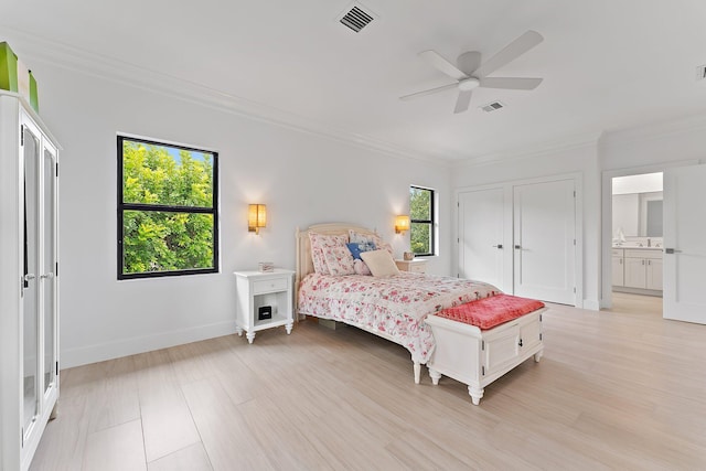 bedroom with ensuite bath, ceiling fan, light hardwood / wood-style flooring, and ornamental molding