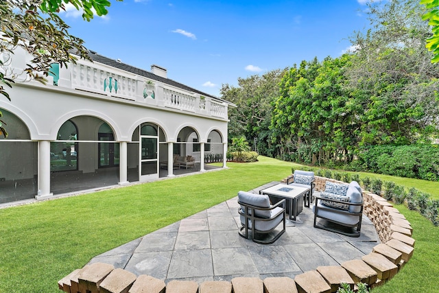 view of patio with an outdoor living space with a fire pit and a grill