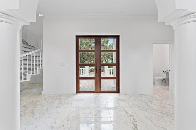 entryway with decorative columns, baseboards, stairway, marble finish floor, and crown molding