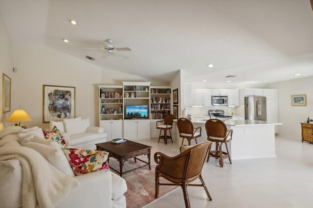 living room featuring high vaulted ceiling and ceiling fan