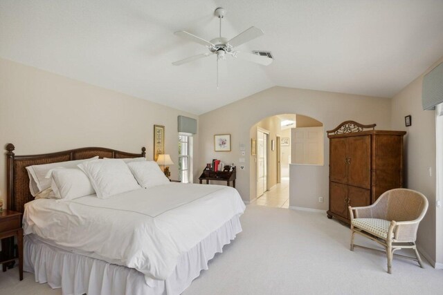 carpeted bedroom featuring lofted ceiling and ceiling fan