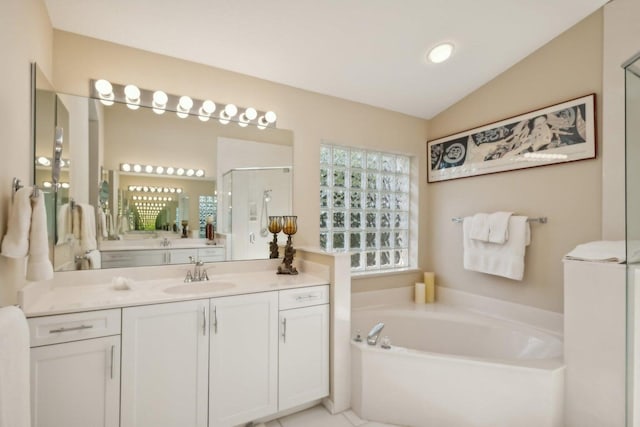 bathroom with lofted ceiling, vanity, and independent shower and bath