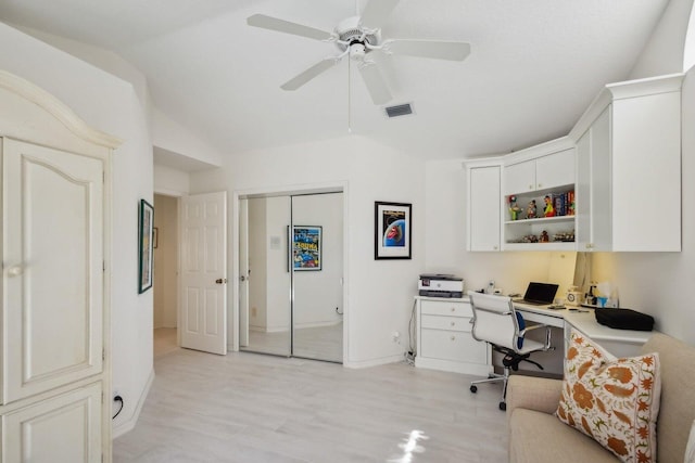 home office featuring lofted ceiling, light hardwood / wood-style flooring, and ceiling fan