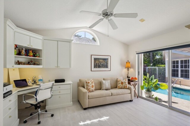 office area featuring a healthy amount of sunlight, ceiling fan, light hardwood / wood-style floors, and vaulted ceiling