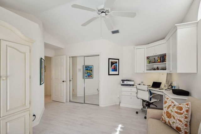 office space with ceiling fan, vaulted ceiling, and light hardwood / wood-style flooring