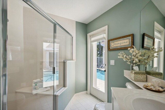 bathroom featuring tile patterned flooring, vanity, toilet, and an enclosed shower