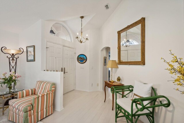 entrance foyer with high vaulted ceiling and a notable chandelier