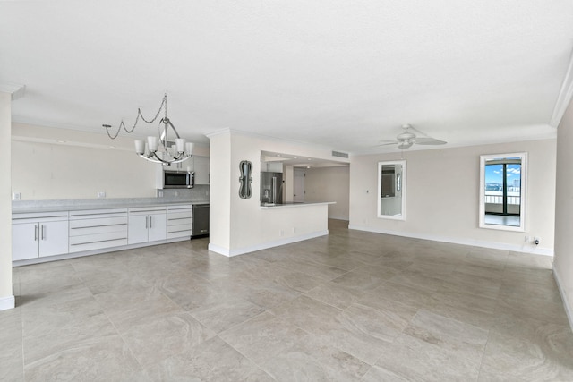 unfurnished living room with visible vents, ceiling fan with notable chandelier, baseboards, and ornamental molding