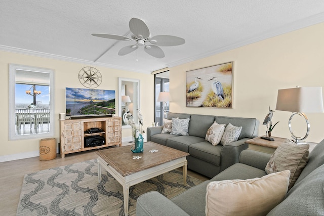 living room featuring baseboards, a textured ceiling, ceiling fan, and crown molding