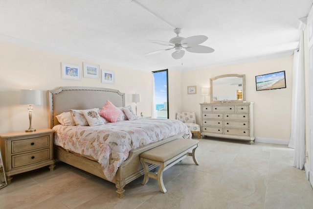 bedroom featuring baseboards, ceiling fan, and crown molding