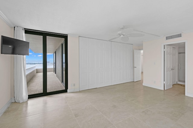 unfurnished room with a ceiling fan, visible vents, and baseboards