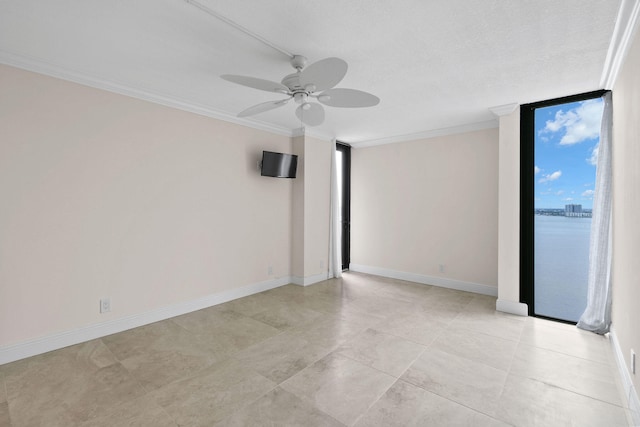 unfurnished room featuring a wall of windows, crown molding, a ceiling fan, and baseboards