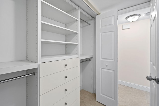 walk in closet featuring light tile patterned flooring