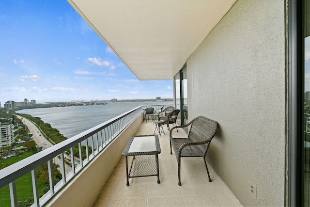 balcony featuring a city view and a water view