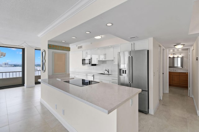 kitchen featuring stainless steel appliances, plenty of natural light, visible vents, and white cabinets