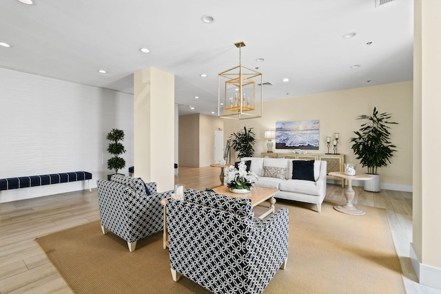 living room with light hardwood / wood-style flooring and an inviting chandelier